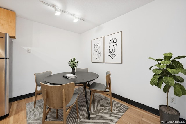 2800 44th St Unit 401, Minneapolis, MN 55410 - dining space with light wood-style floors and track lighting