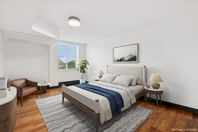 2800 44th St Unit 401, Minneapolis, MN 55410 - bedroom featuring light wood-style flooring and baseboards