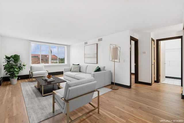 2800 44th St Unit 401, Minneapolis, MN 55410 - living room featuring light wood-type flooring and a baseboard heating unit