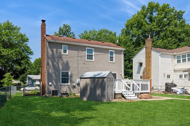 1290 Matilda St, Saint Paul, MN 55117 - rear view of house featuring a chimney, a shed, and a deck