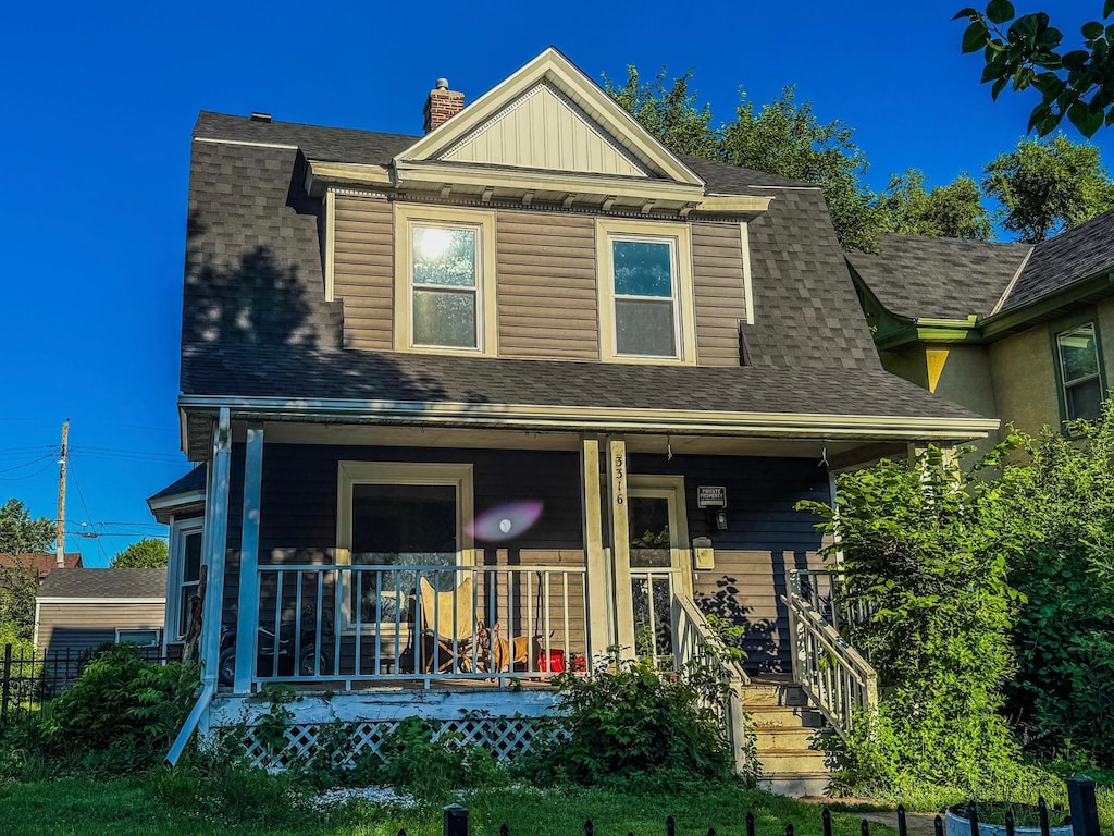 3316 5th Ave S, Minneapolis, MN 55408 - view of front of property featuring a porch, roof with shingles, and a chimney