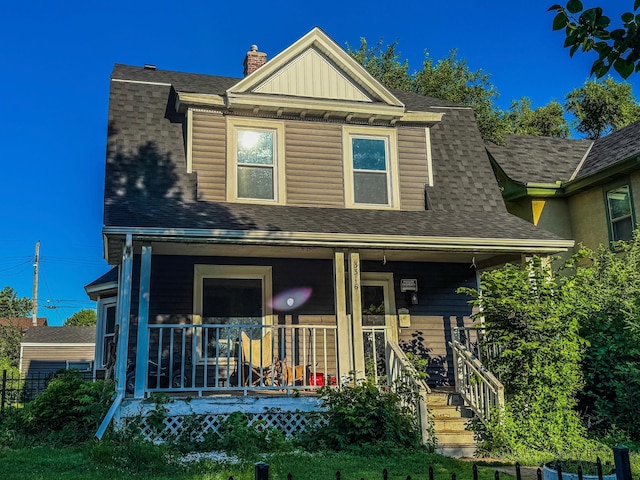 3316 5th Ave S, Minneapolis, MN 55408 - view of front of property featuring a porch, roof with shingles, and a chimney