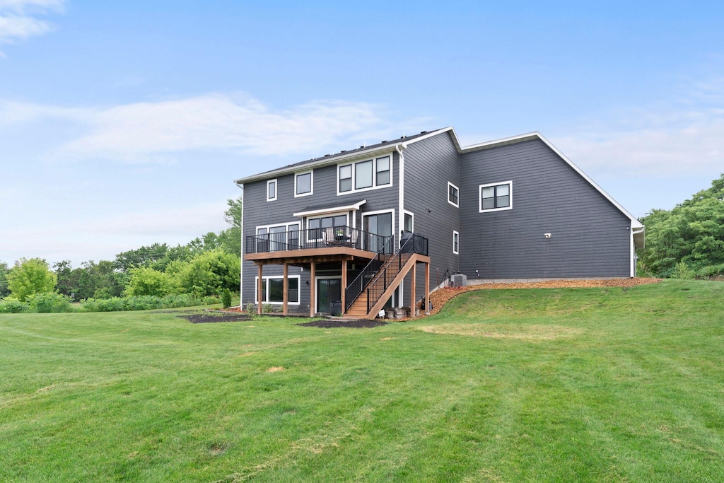 8750 Vernon St, Greenfield, MN 55373 - back of house featuring a wooden deck, stairs, and a yard