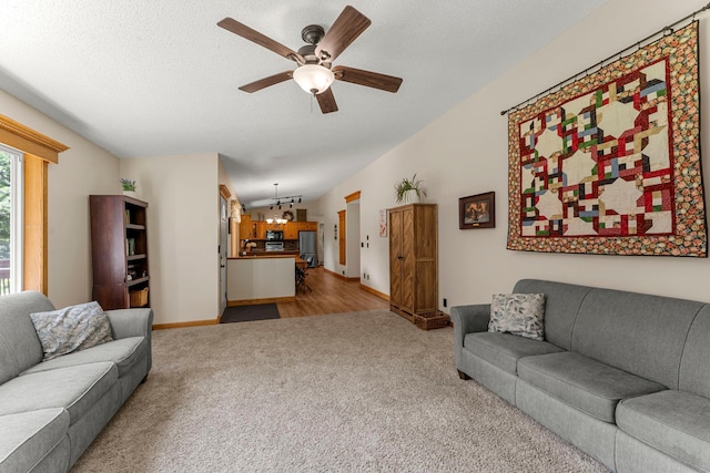 4508 192nd St, Fair Haven Twp, MN 55382 - living area featuring light colored carpet, a ceiling fan, and a chandelier