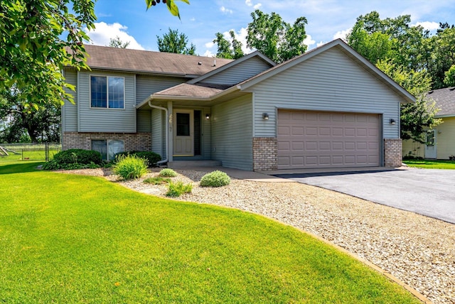 6617 378th St, North Branch, MN 55056 - split level home featuring brick siding, an attached garage, and driveway