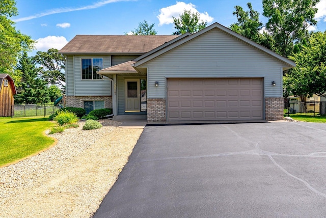 6617 378th St, North Branch, MN 55056 - view of front facade with brick siding, an attached garage, and driveway