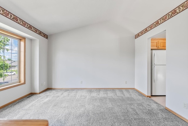 6617 378th St, North Branch, MN 55056 - spare room featuring light colored carpet and vaulted ceiling
