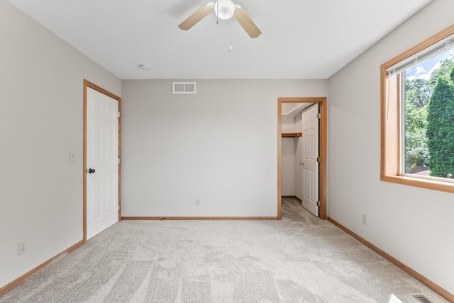 6617 378th St, North Branch, MN 55056 - unfurnished bedroom featuring light carpet, a spacious closet, and a ceiling fan