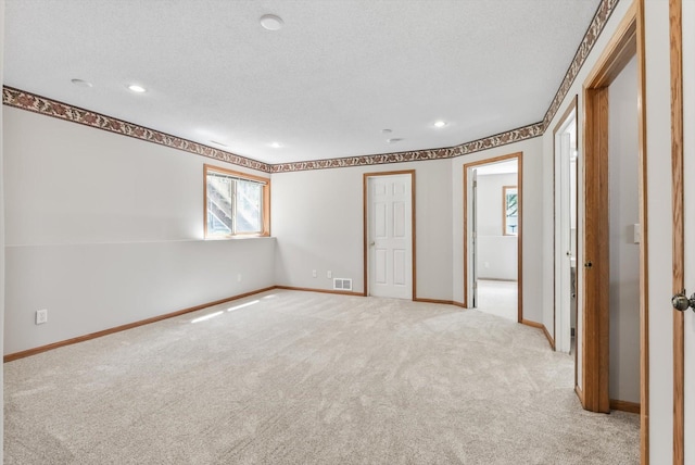 6617 378th St, North Branch, MN 55056 - unfurnished bedroom with light carpet, recessed lighting, and a textured ceiling