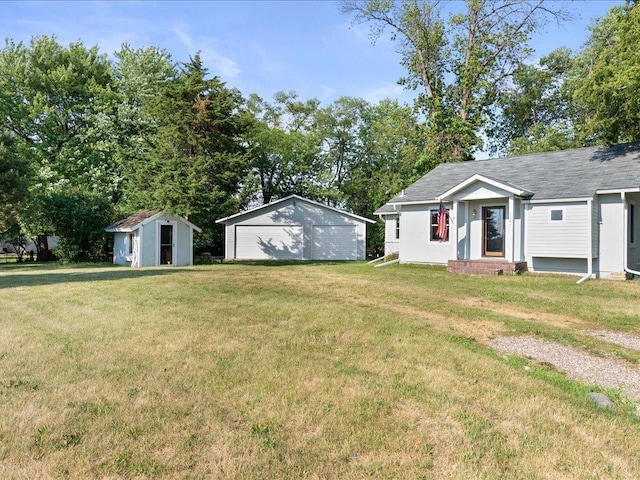7247 Eden Prairie Rd, Eden Prairie, MN 55346 - view of green lawn with a detached garage, entry steps, and a storage unit