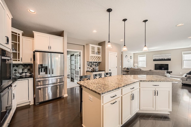 1535 138th St E, Rosemount, MN 55068 - kitchen featuring appliances with stainless steel finishes, open floor plan, a center island, glass insert cabinets, and recessed lighting