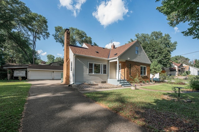 1595 Reaney Ave, Saint Paul, MN 55106 - view of front facade featuring a chimney, a detached garage, a front yard, brick siding, and a shingled roof