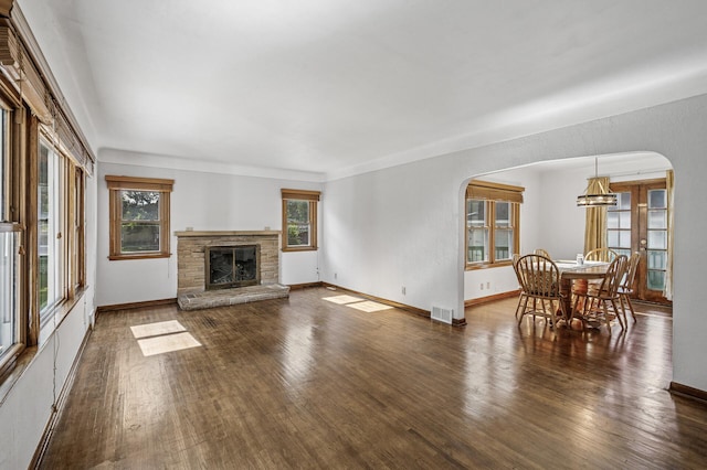 1595 Reaney Ave, Saint Paul, MN 55106 - living area featuring arched walkways, plenty of natural light, and wood finished floors