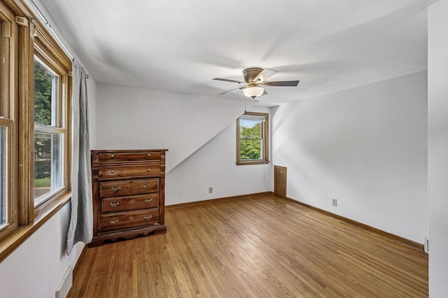 1595 Reaney Ave, Saint Paul, MN 55106 - spare room with wood finished floors, ceiling fan, and vaulted ceiling