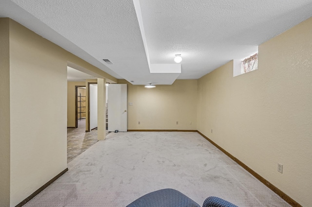 1595 Reaney Ave, Saint Paul, MN 55106 - basement featuring a textured ceiling, light colored carpet, and a textured wall