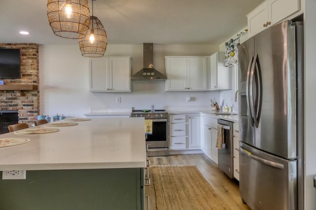 8112 Shore Trl N, Forest Lake, MN 55025 - kitchen with appliances with stainless steel finishes, wall chimney exhaust hood, light countertops, white cabinets, and light wood-style floors