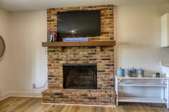 8112 Shore Trl N, Forest Lake, MN 55025 - detailed view of wood finished floors and a brick fireplace