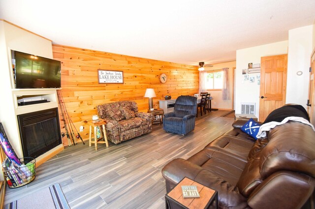 14590 Gazebo Dr Unit 10, Park Rapids, MN 56470 - living room with a fireplace, wood finished floors, and wooden walls
