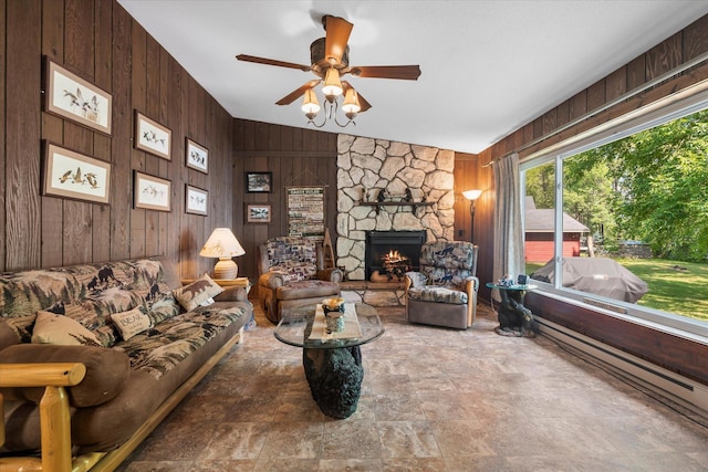 36977 Shoreland Rd, Sturgeon Lake, MN 55783 - living room featuring wood walls, stone finish floors, ceiling fan, a fireplace, and lofted ceiling