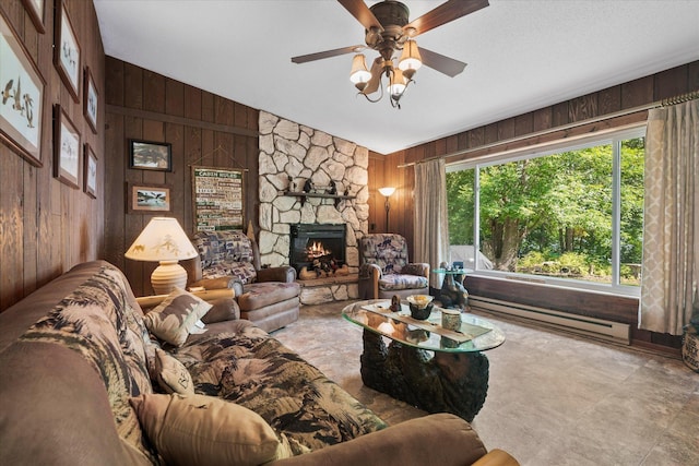 36977 Shoreland Rd, Sturgeon Lake, MN 55783 - living room with wooden walls, vaulted ceiling, a stone fireplace, ceiling fan, and a baseboard radiator