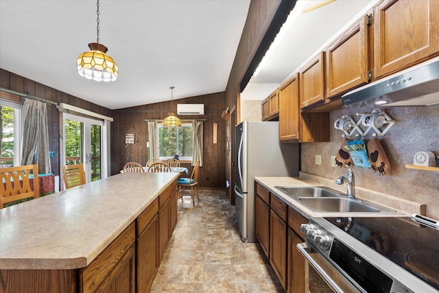 36977 Shoreland Rd, Sturgeon Lake, MN 55783 - kitchen featuring range, vaulted ceiling, wood walls, backsplash, and brown cabinetry
