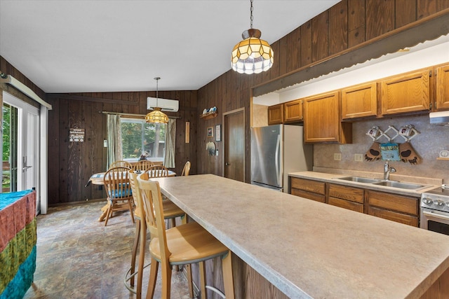 36977 Shoreland Rd, Sturgeon Lake, MN 55783 - kitchen with freestanding refrigerator, wood walls, a wall mounted air conditioner, backsplash, and light countertops