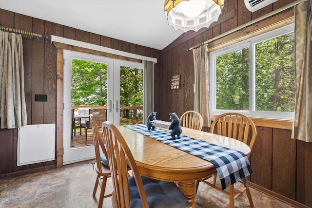 36977 Shoreland Rd, Sturgeon Lake, MN 55783 - dining space featuring wooden walls, french doors, stone finish flooring, an AC wall unit, and vaulted ceiling