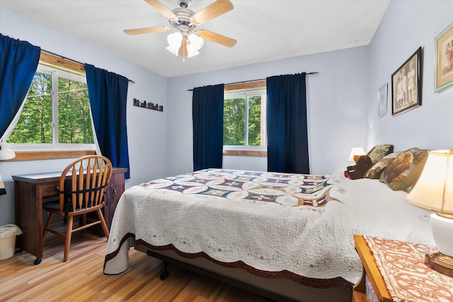 36977 Shoreland Rd, Sturgeon Lake, MN 55783 - bedroom featuring multiple windows, wood finished floors, and a ceiling fan
