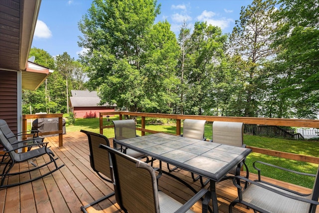 36977 Shoreland Rd, Sturgeon Lake, MN 55783 - wooden terrace with outdoor dining area and a lawn