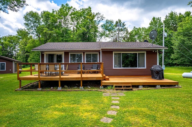 36977 Shoreland Rd, Sturgeon Lake, MN 55783 - back of property featuring a deck, a lawn, and a shingled roof