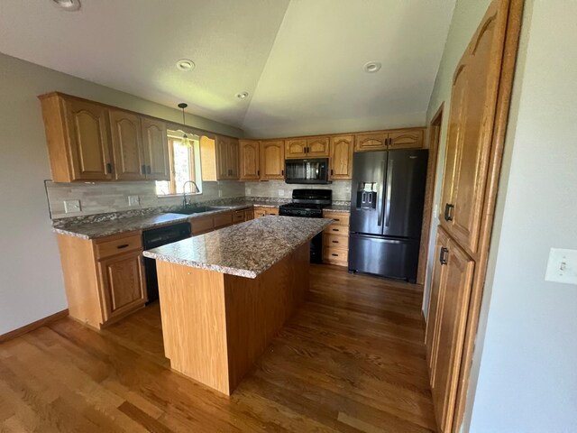 13205 Lake Place Rd, Baldwin Twp, MN 55398 - kitchen featuring black appliances, dark wood-style floors, a kitchen island, decorative backsplash, and vaulted ceiling