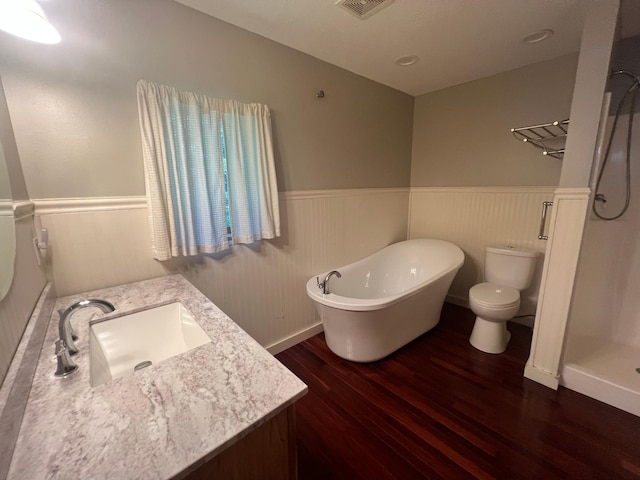 13205 Lake Place Rd, Baldwin Twp, MN 55398 - bathroom with wood finished floors, vanity, wainscoting, and a soaking tub