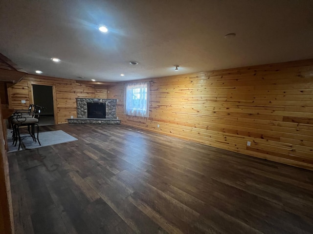 13205 Lake Place Rd, Baldwin Twp, MN 55398 - unfurnished living room featuring wood walls, a fireplace, dark wood-style floors, and recessed lighting