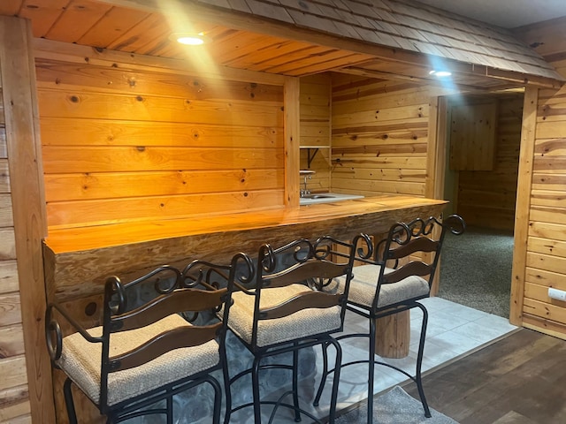 13205 Lake Place Rd, Baldwin Twp, MN 55398 - dining space featuring wood walls, bar with sink, wooden ceiling, and a sauna / steam room
