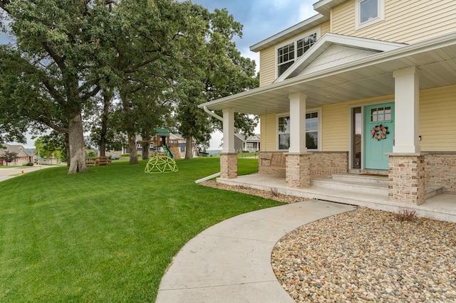 2990 Pinewood Ridge Dr SE, Rochester, MN 55904 - entrance to property with a yard, a porch, and brick siding