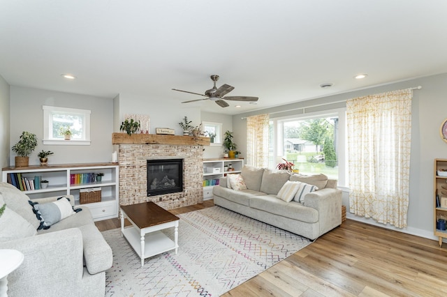 2990 Pinewood Ridge Dr SE, Rochester, MN 55904 - living room with healthy amount of natural light, wood finished floors, a fireplace, and recessed lighting