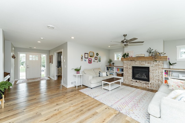 2990 Pinewood Ridge Dr SE, Rochester, MN 55904 - living room featuring recessed lighting, wood finished floors, ceiling fan, and a glass covered fireplace