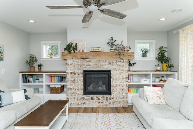 2990 Pinewood Ridge Dr SE, Rochester, MN 55904 - living room featuring wood finished floors, plenty of natural light, a fireplace, a ceiling fan, and recessed lighting