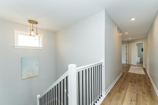 2990 Pinewood Ridge Dr SE, Rochester, MN 55904 - hallway featuring an upstairs landing, wood finished floors, and recessed lighting