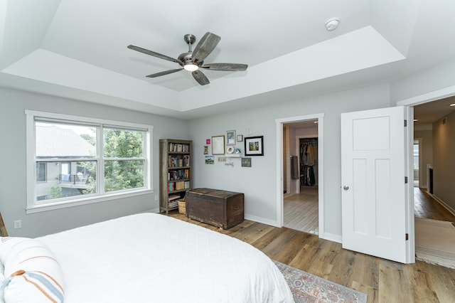 2990 Pinewood Ridge Dr SE, Rochester, MN 55904 - bedroom featuring a tray ceiling, wood finished floors, and ceiling fan