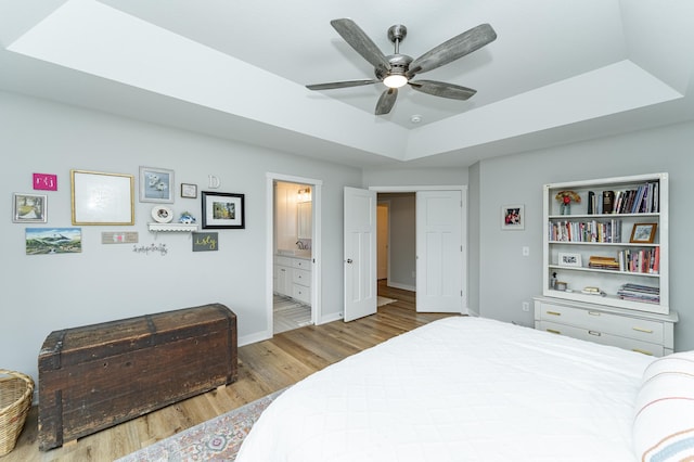 2990 Pinewood Ridge Dr SE, Rochester, MN 55904 - bedroom featuring a raised ceiling, wood finished floors, ensuite bathroom, and ceiling fan