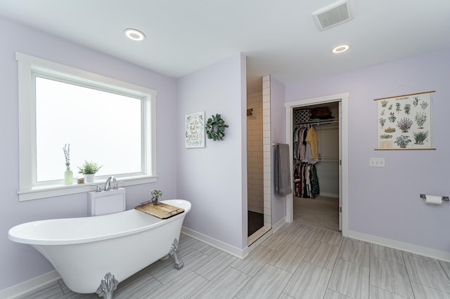 2990 Pinewood Ridge Dr SE, Rochester, MN 55904 - full bath featuring a freestanding tub, a tile shower, a walk in closet, and recessed lighting