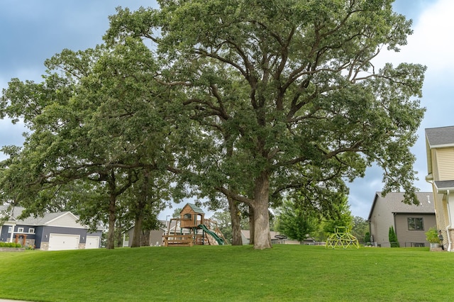 2990 Pinewood Ridge Dr SE, Rochester, MN 55904 - view of grassy yard with a playground and a garage