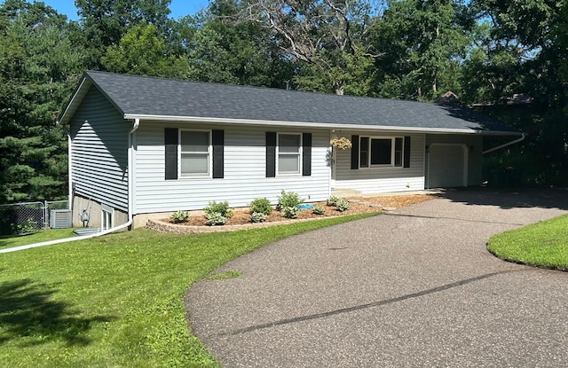 651 4th St N, North Hudson, WI 54016 - single story home with driveway, roof with shingles, and view of wooded area