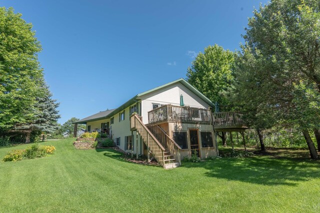 44198 Mosquito Trl, Pine Lake Twp, MN 56573 - back of property with stairway, a deck, and a lawn