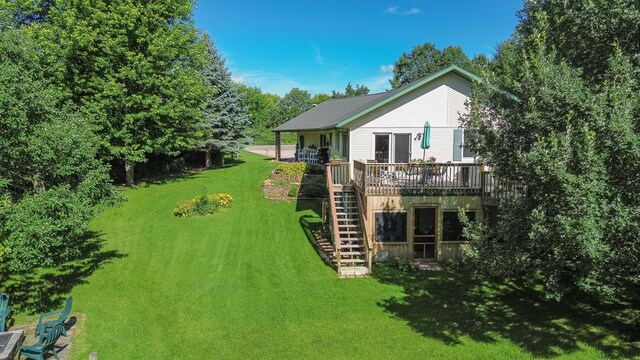44198 Mosquito Trl, Pine Lake Twp, MN 56573 - view of grassy yard with stairway and a wooden deck