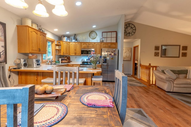 44198 Mosquito Trl, Pine Lake Twp, MN 56573 - kitchen with stainless steel appliances, vaulted ceiling, light countertops, a peninsula, and light wood-style floors