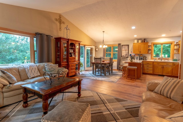 44198 Mosquito Trl, Pine Lake Twp, MN 56573 - living area with a chandelier, vaulted ceiling, light wood-style floors, and recessed lighting