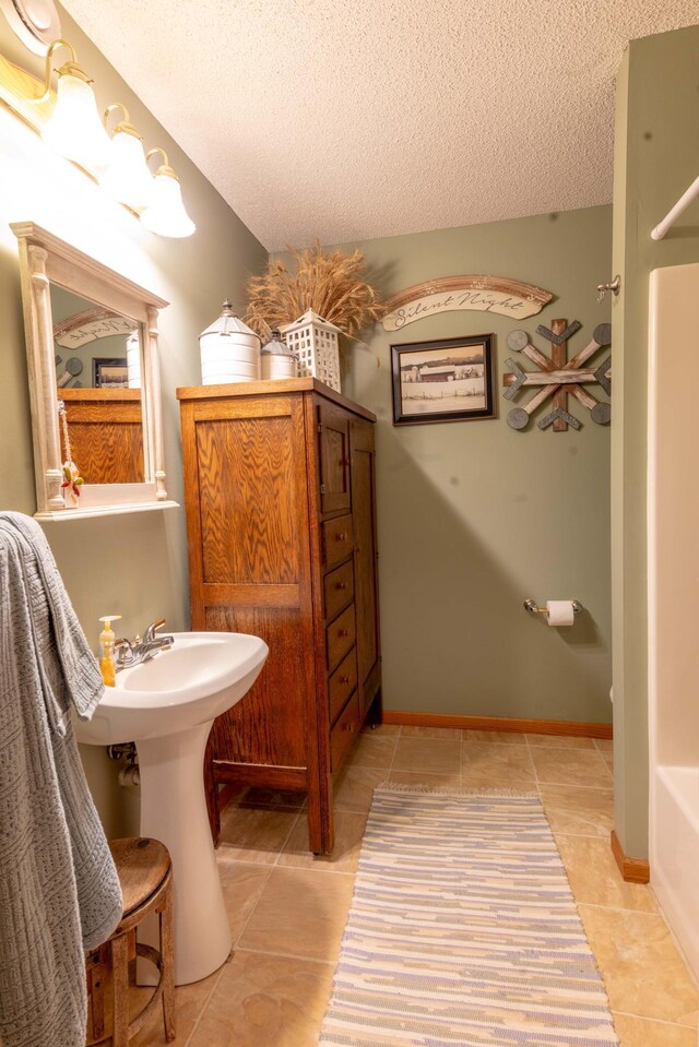44198 Mosquito Trl, Pine Lake Twp, MN 56573 - full bath with tile patterned flooring, a textured ceiling, and a tub to relax in