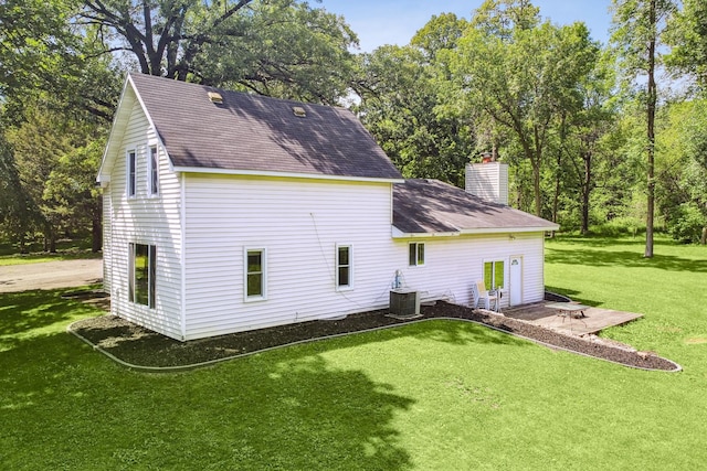 66578 330th St, Watkins, MN 55389 - rear view of property featuring a chimney, a lawn, and a shingled roof